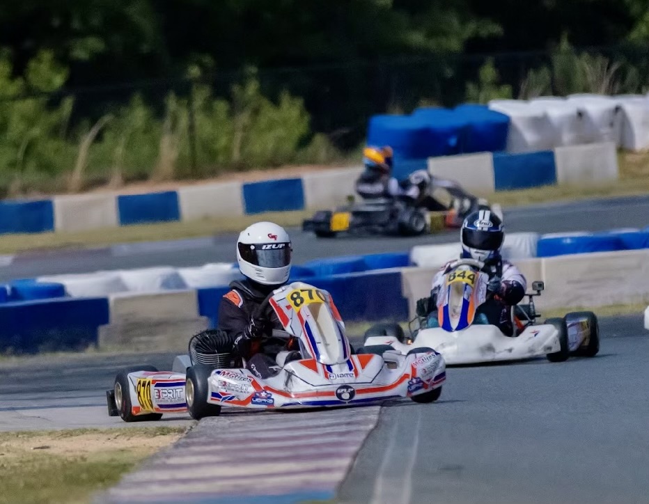 Two karts racing wheel to wheel on track