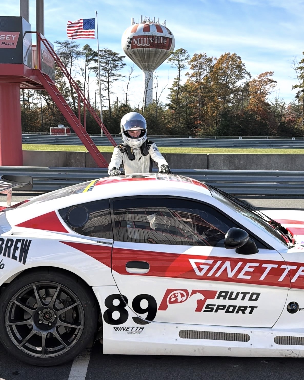 Hayden standing on the No. 89 PT Auto Sport Ginetta G56 at New Jersey Motorsports Park