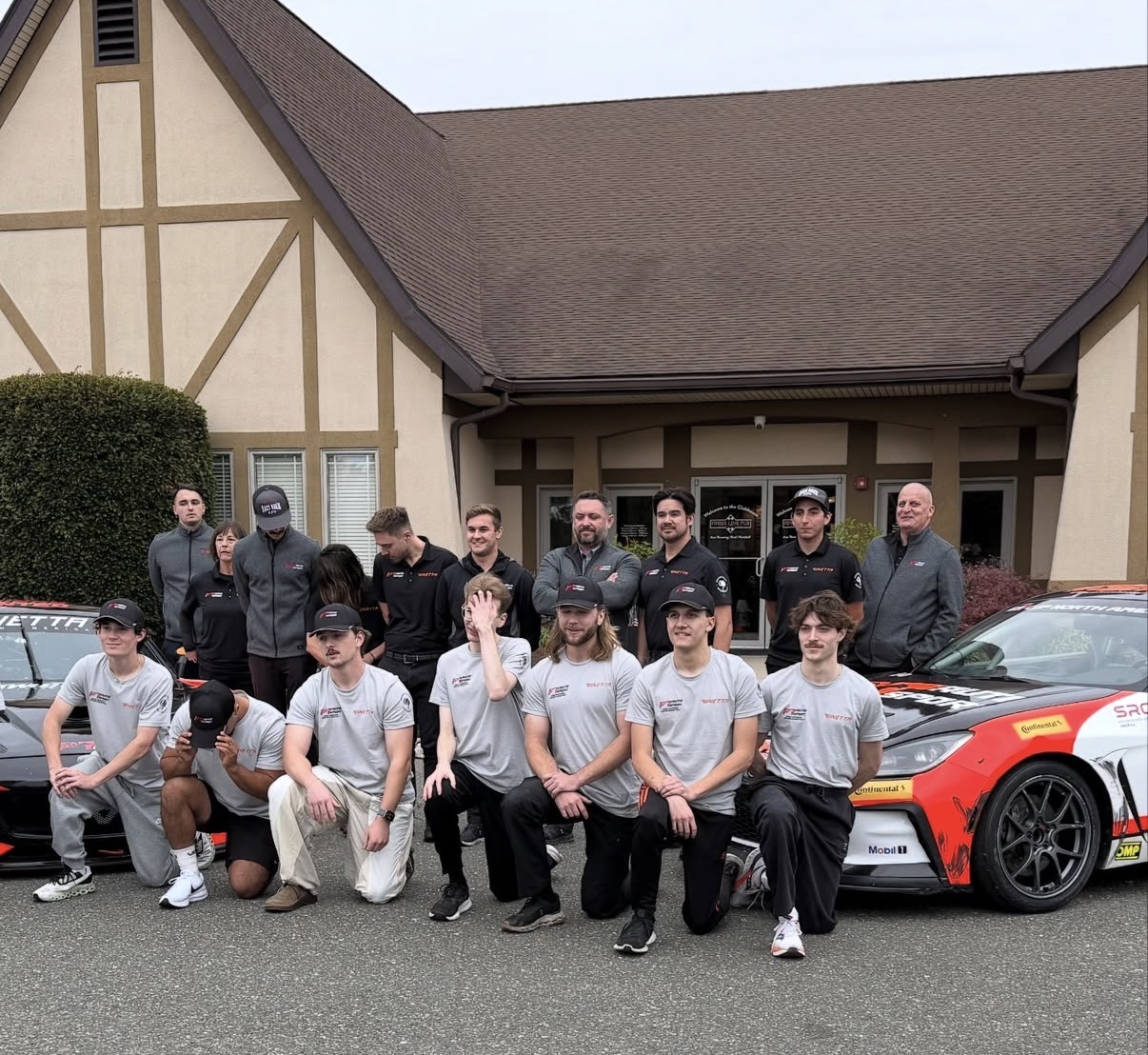 The PT Auto Sport Ginetta racing team posing together outside the clubhouse