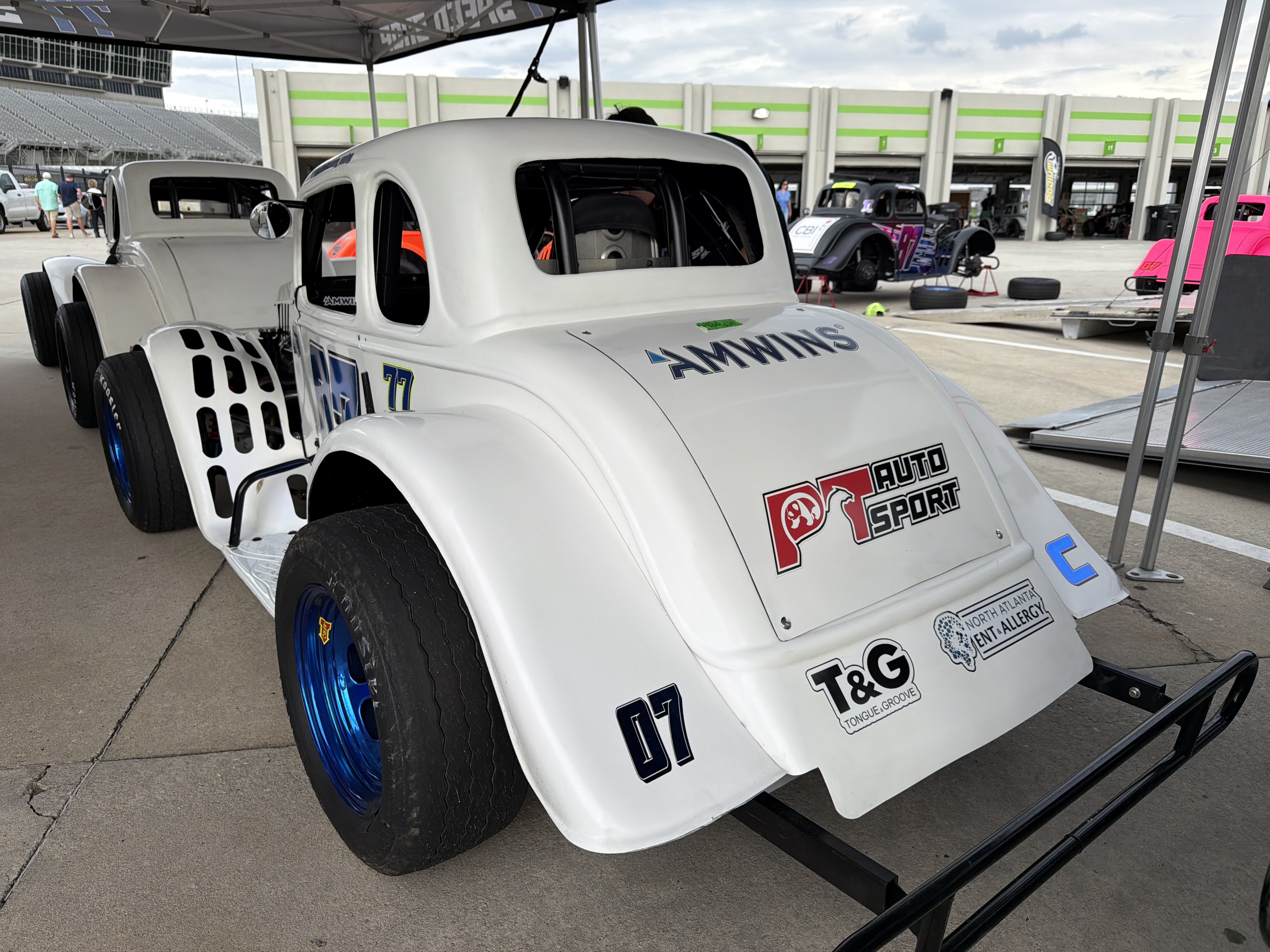 The No. 07 car in the pit area with sponsor logos on the rear quarter panel