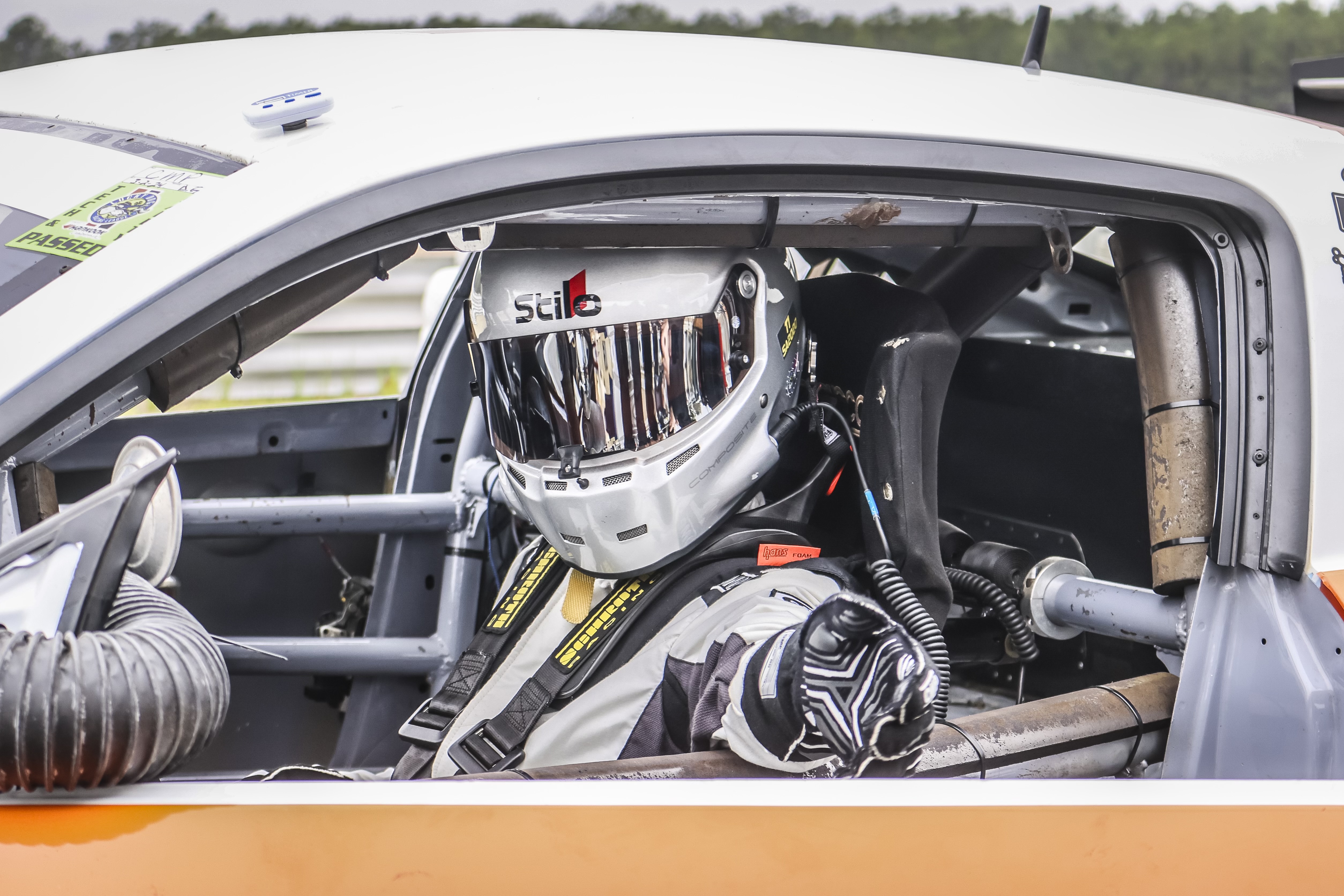 Hayden strapped into a race car cockpit wearing a Stilo helmet